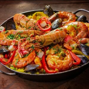 A vibrant and flavorful seafood paella served in a pan with mussels and shrimp.